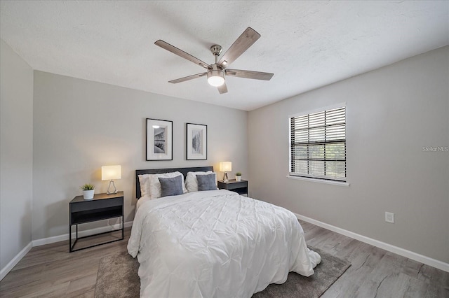 400 E Baffin Dr, Venice, FL 34293 - bedroom with light wood-style floors, ceiling fan, and a textured ceiling