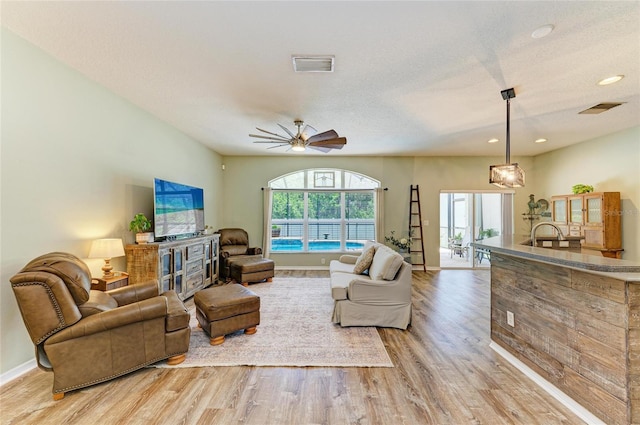 11254 82nd St E, Parrish, FL 34219 - living room with light wood-type flooring, a ceiling fan, recessed lighting, and baseboards