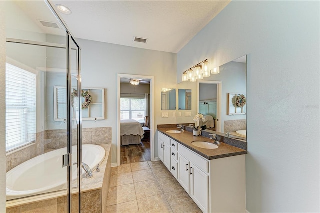 11254 82nd St E, Parrish, FL 34219 - full bath with double vanity, ensuite bathroom, a bath, and a stall shower