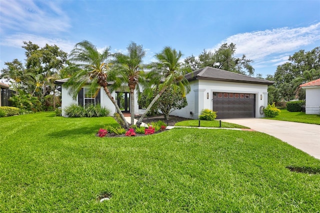 5285 Far Oak Cir, Sarasota, FL 34238 - view of front facade with an attached garage, concrete driveway, a front lawn, and stucco siding