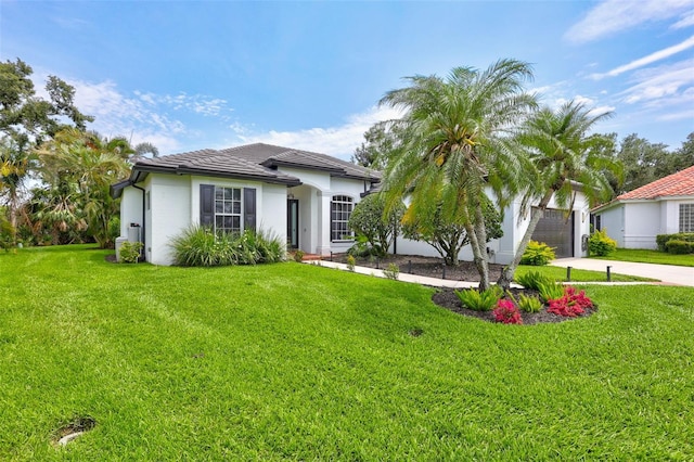5285 Far Oak Cir, Sarasota, FL 34238 - view of front facade with driveway, a front lawn, stucco siding, and a garage