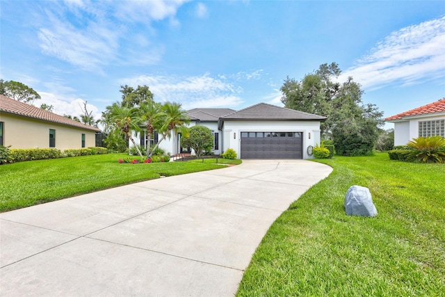 5285 Far Oak Cir, Sarasota, FL 34238 - view of front of home with an attached garage, a front lawn, concrete driveway, and stucco siding