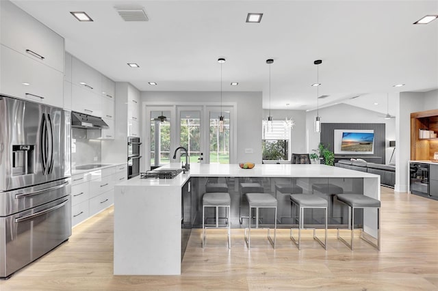 5285 Far Oak Cir, Sarasota, FL 34238 - kitchen with stainless steel appliances, modern cabinets, white cabinetry, light wood-style floors, and recessed lighting