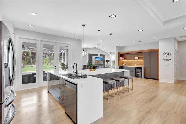5285 Far Oak Cir, Sarasota, FL 34238 - kitchen with stainless steel appliances, a sink, modern cabinets, wine cooler, and a large island