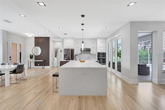 5285 Far Oak Cir, Sarasota, FL 34238 - kitchen featuring modern cabinets, stainless steel fridge with ice dispenser, white cabinetry, light wood-type flooring, and recessed lighting