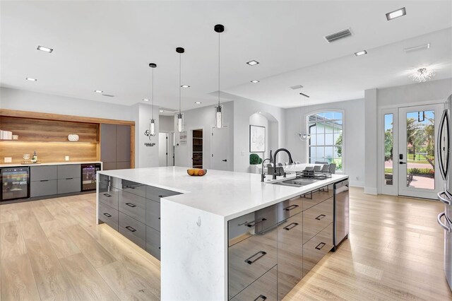 5285 Far Oak Cir, Sarasota, FL 34238 - kitchen featuring beverage cooler, gray cabinets, modern cabinets, light wood finished floors, and recessed lighting
