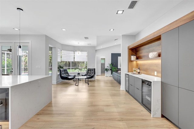 5285 Far Oak Cir, Sarasota, FL 34238 - kitchen with modern cabinets, wine cooler, light wood-type flooring, open shelves, and light countertops