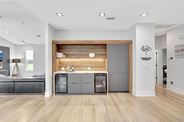 5285 Far Oak Cir, Sarasota, FL 34238 - indoor bar featuring beverage cooler, light wood-type flooring, baseboards, ceiling fan, and recessed lighting