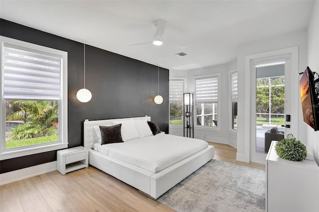 5285 Far Oak Cir, Sarasota, FL 34238 - bedroom with light wood finished floors, baseboards, ceiling fan, and access to exterior