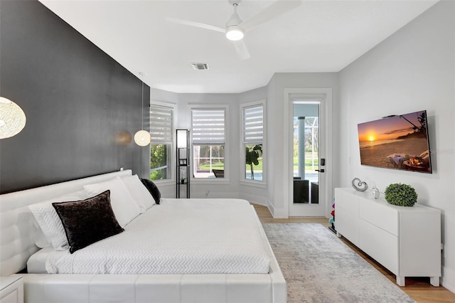 5285 Far Oak Cir, Sarasota, FL 34238 - bedroom with light wood-style flooring, a ceiling fan, baseboards, and access to outside