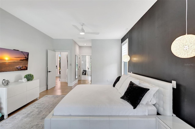 5285 Far Oak Cir, Sarasota, FL 34238 - bedroom featuring light wood finished floors, baseboards, and a ceiling fan
