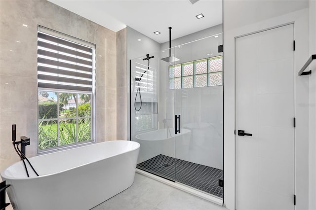 5285 Far Oak Cir, Sarasota, FL 34238 - bathroom featuring a stall shower and a freestanding tub