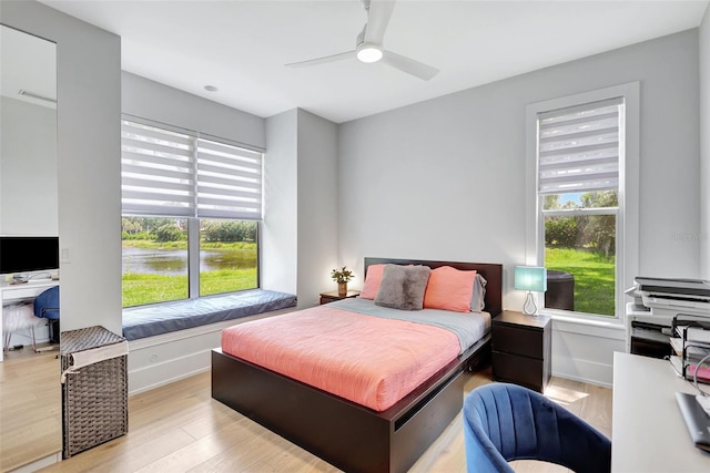 5285 Far Oak Cir, Sarasota, FL 34238 - bedroom with multiple windows, wood finished floors, baseboards, and a ceiling fan
