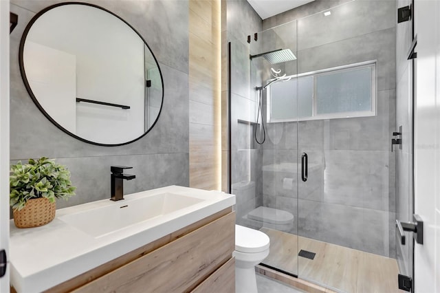 5285 Far Oak Cir, Sarasota, FL 34238 - bathroom with toilet, a stall shower, tile walls, and vanity