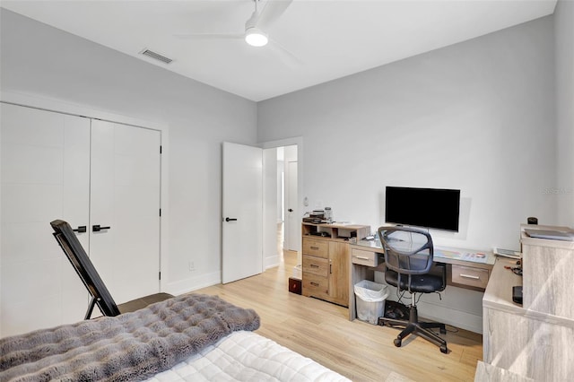 5285 Far Oak Cir, Sarasota, FL 34238 - bedroom featuring light wood-type flooring, baseboards, an office area, ceiling fan, and a closet
