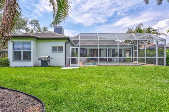 5285 Far Oak Cir, Sarasota, FL 34238 - back of house featuring a chimney, stucco siding, a yard, glass enclosure, and an outdoor pool