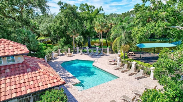 5285 Far Oak Cir, Sarasota, FL 34238 - community pool featuring a patio area and view of scattered trees
