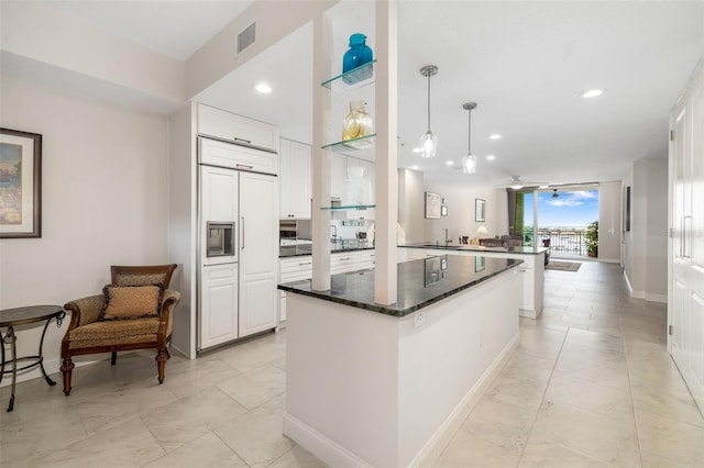 610 Riviera Dunes Way Unit 503, Palmetto, FL 34221 - kitchen with a center island, white cabinets, baseboards, a sink, and recessed lighting
