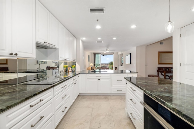 610 Riviera Dunes Way Unit 503, Palmetto, FL 34221 - kitchen with black electric cooktop, a peninsula, recessed lighting, white cabinetry, and a sink