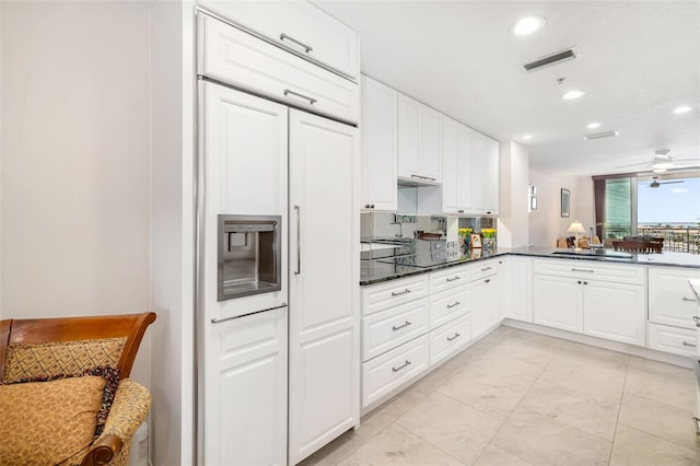 610 Riviera Dunes Way Unit 503, Palmetto, FL 34221 - kitchen with white cabinetry, recessed lighting, a sink, paneled fridge, and ceiling fan