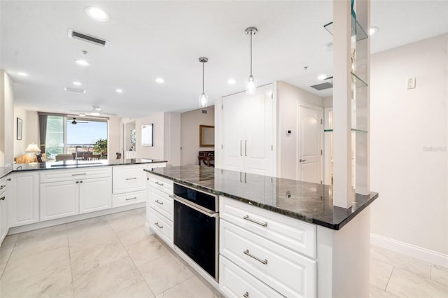 610 Riviera Dunes Way Unit 503, Palmetto, FL 34221 - kitchen with oven, a sink, white cabinets, recessed lighting, and baseboards