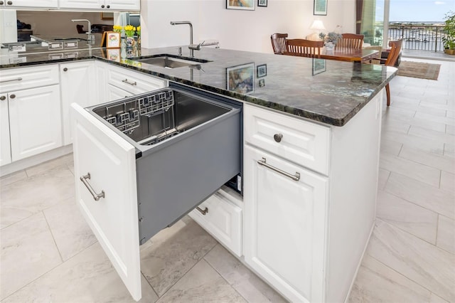 610 Riviera Dunes Way Unit 503, Palmetto, FL 34221 - kitchen with a sink, white cabinetry, dark stone counters, and a peninsula