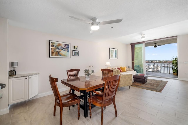 610 Riviera Dunes Way Unit 503, Palmetto, FL 34221 - dining room featuring ceiling fan and a textured ceiling