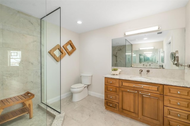 610 Riviera Dunes Way Unit 503, Palmetto, FL 34221 - bathroom featuring vanity, toilet, a walk in shower, baseboards, and marble look tile flooring
