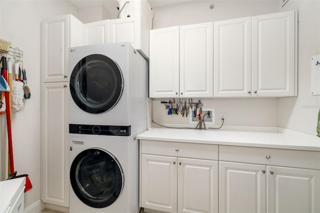 610 Riviera Dunes Way Unit 503, Palmetto, FL 34221 - laundry area with stacked washer / dryer and cabinet space