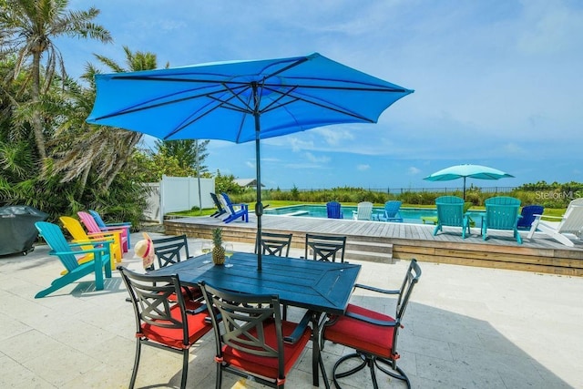 102 77th St, Holmes Beach, FL 34217 - view of patio with a swimming pool, outdoor dining space, and a grill