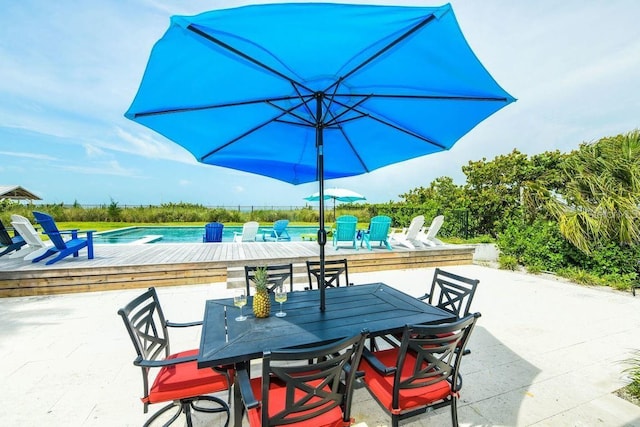 102 77th St, Holmes Beach, FL 34217 - view of patio / terrace with outdoor dining space and a pool