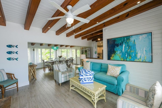 102 77th St, Holmes Beach, FL 34217 - living area featuring wood finished floors, beamed ceiling, ceiling fan, and wooden walls