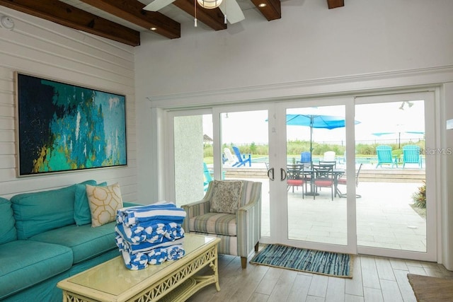 102 77th St, Holmes Beach, FL 34217 - living room featuring beam ceiling, a ceiling fan, light wood-type flooring, and wooden walls