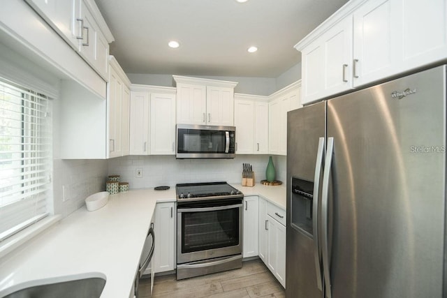102 77th St, Holmes Beach, FL 34217 - kitchen featuring stainless steel appliances, light countertops, white cabinetry, and recessed lighting