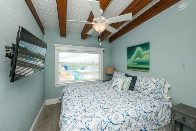 102 77th St, Holmes Beach, FL 34217 - bedroom with wood finished floors, beam ceiling, baseboards, and a ceiling fan