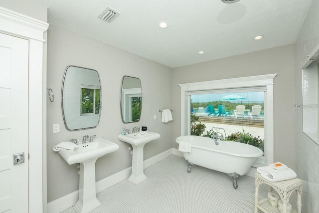 102 77th St, Holmes Beach, FL 34217 - bathroom featuring a freestanding bath, baseboards, and recessed lighting