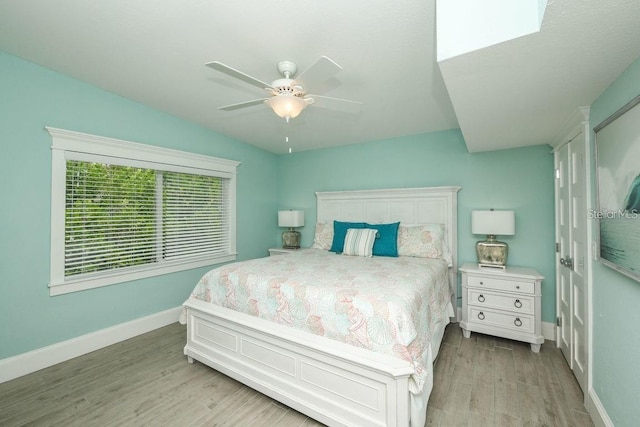 102 77th St, Holmes Beach, FL 34217 - bedroom with light wood finished floors, baseboards, and a ceiling fan