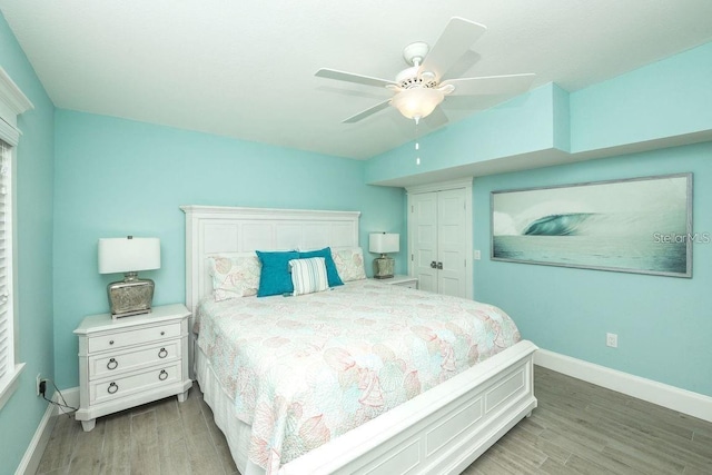 102 77th St, Holmes Beach, FL 34217 - bedroom with light wood-style flooring, baseboards, and a ceiling fan