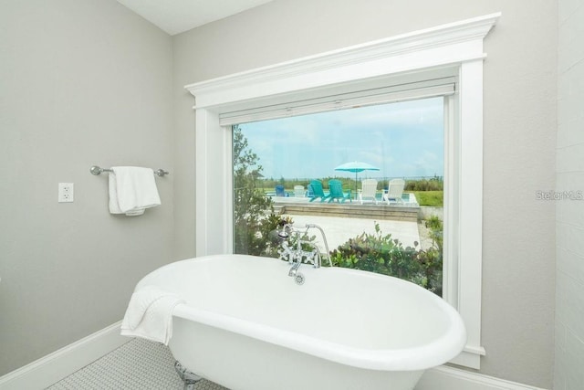 102 77th St, Holmes Beach, FL 34217 - bathroom featuring a freestanding tub, baseboards, and tile patterned flooring