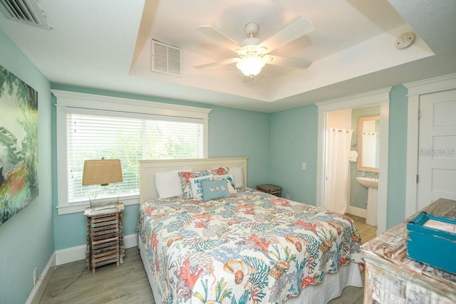 102 77th St, Holmes Beach, FL 34217 - bedroom with multiple windows, wood finished floors, baseboards, and ceiling fan