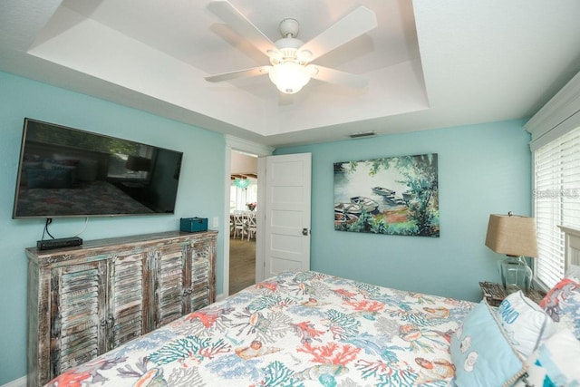 102 77th St, Holmes Beach, FL 34217 - bedroom featuring a tray ceiling and ceiling fan