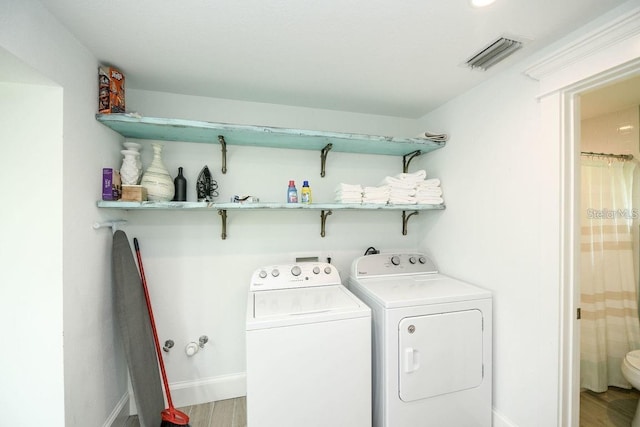 102 77th St, Holmes Beach, FL 34217 - washroom featuring washer and dryer, wood finished floors, and baseboards