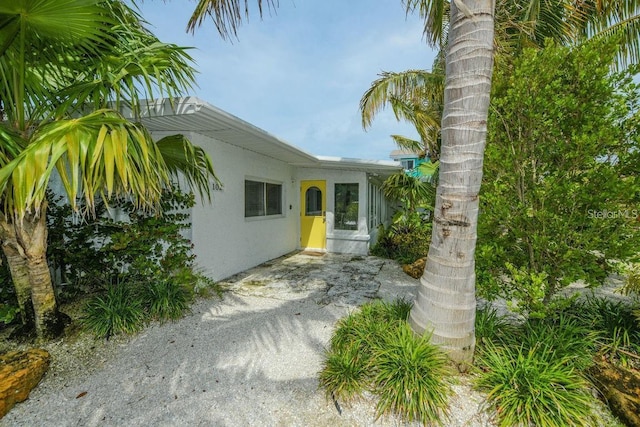 102 77th St, Holmes Beach, FL 34217 - property entrance with stucco siding