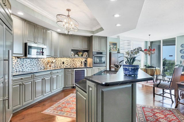401 N Point Rd Unit 504, Osprey, FL 34229 - kitchen featuring appliances with stainless steel finishes, dark countertops, gray cabinetry, crown molding, and recessed lighting