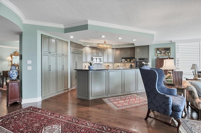 401 N Point Rd Unit 504, Osprey, FL 34229 - kitchen with stainless steel appliances, dark wood-type flooring, gray cabinetry, a textured ceiling, and ornamental molding