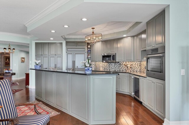 401 N Point Rd Unit 504, Osprey, FL 34229 - kitchen with a chandelier, stainless steel appliances, dark countertops, gray cabinetry, and recessed lighting