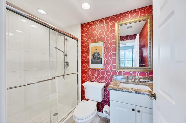 401 N Point Rd Unit 504, Osprey, FL 34229 - bathroom with wallpapered walls, vanity, toilet, a shower stall, and recessed lighting
