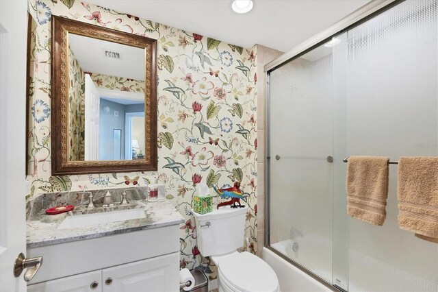 401 N Point Rd Unit 504, Osprey, FL 34229 - full bath with wallpapered walls, vanity, toilet, and combined bath / shower with glass door