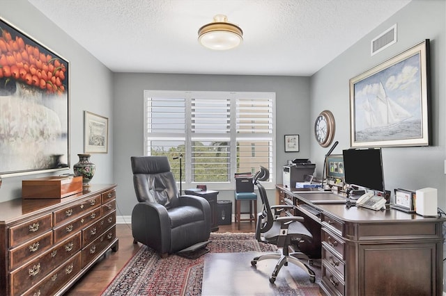 401 N Point Rd Unit 504, Osprey, FL 34229 - home office with dark wood finished floors, a textured ceiling, and baseboards