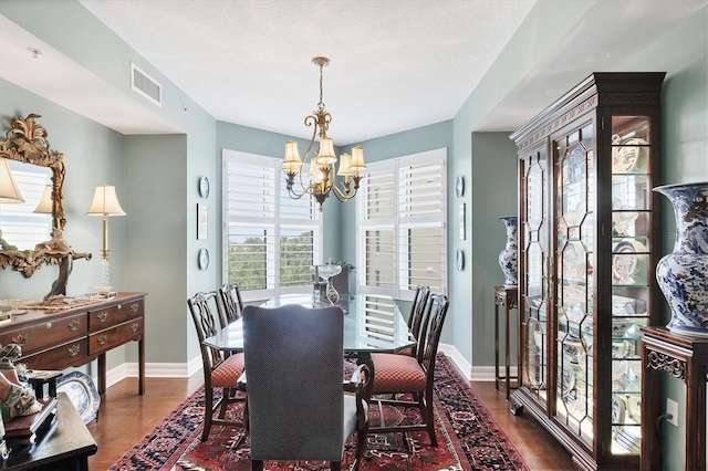 401 N Point Rd Unit 504, Osprey, FL 34229 - dining space with dark wood-style floors, a chandelier, and baseboards